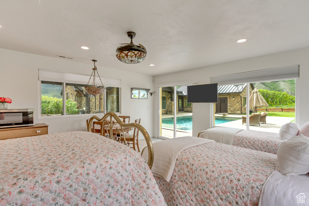 Bedroom featuring access to outside, multiple windows, and recessed lighting