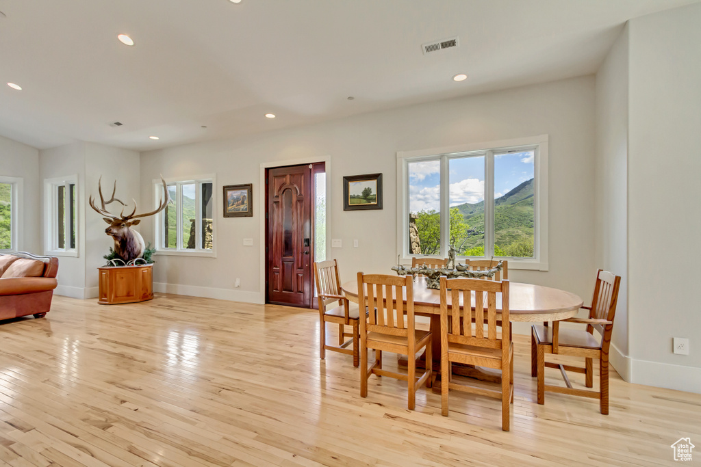 Dining area with light wood-style floors, recessed lighting, and baseboards
