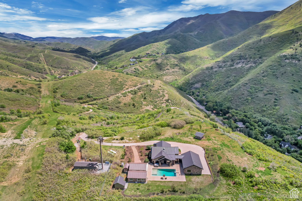 View from above of property with a pool and a mountainous background