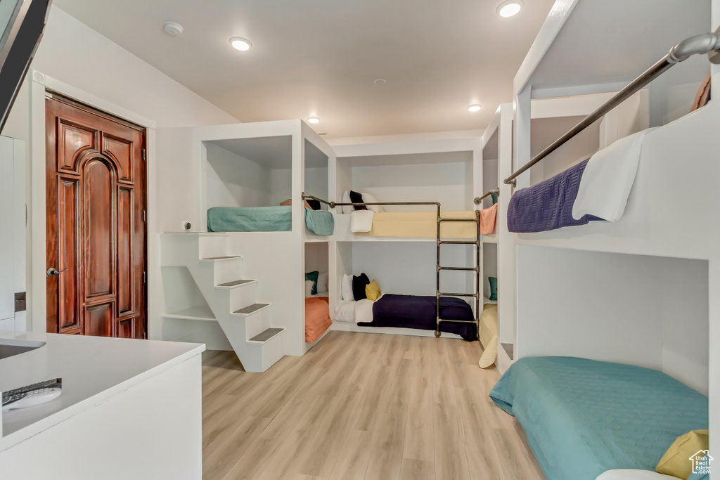 Bedroom with wood finished floors and recessed lighting