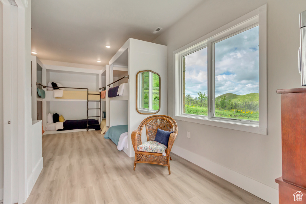 Living area featuring wood finished floors, baseboards, and recessed lighting