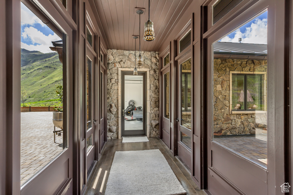 Doorway to outside with french doors, wooden ceiling, dark wood-type flooring, and a mountain view