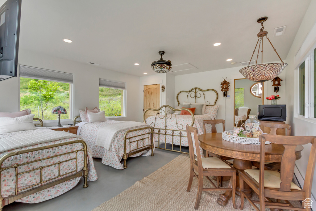 Bedroom featuring finished concrete floors and recessed lighting