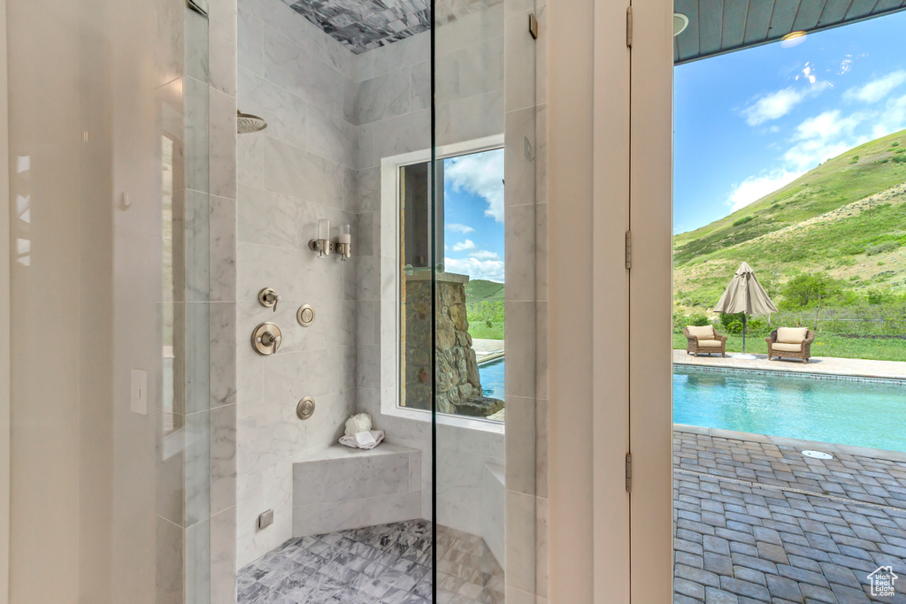 Full bath featuring a tile shower and a mountain view