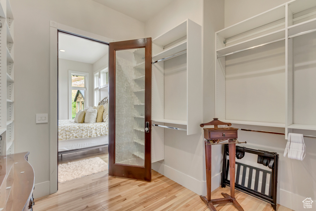 Walk in closet with wood finished floors
