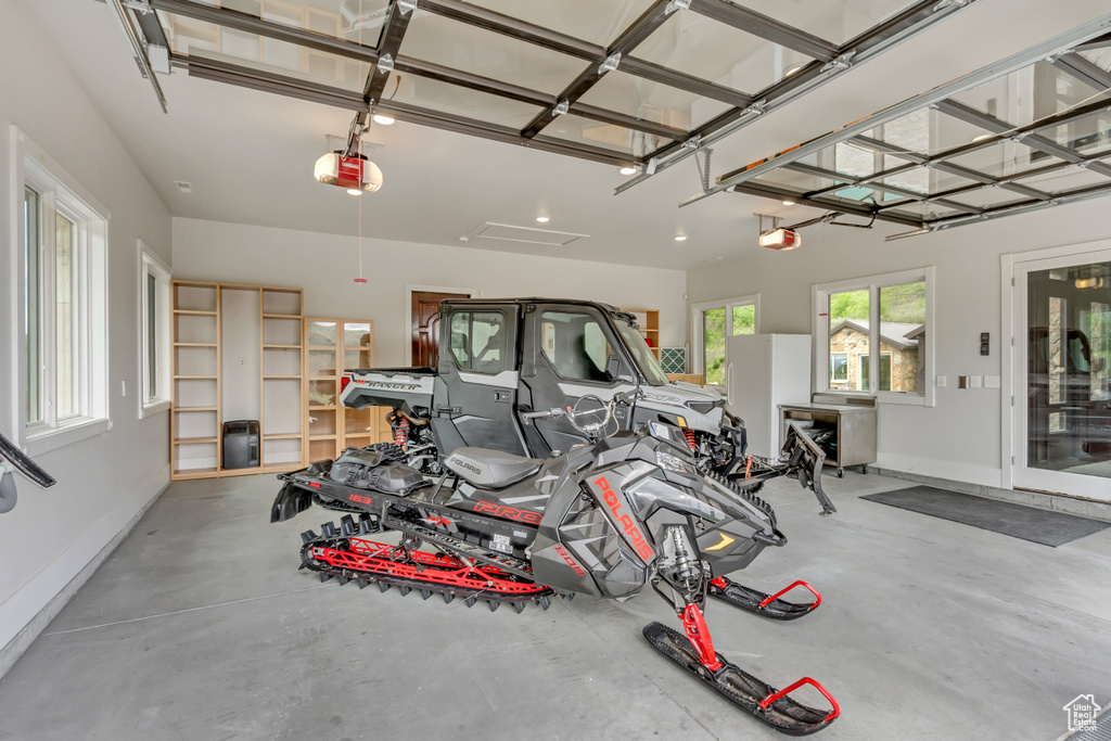 Garage with a garage door opener and baseboards