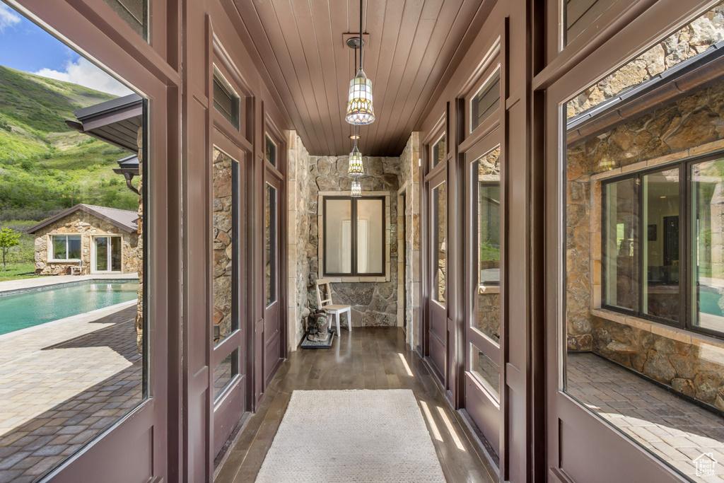Doorway to outside featuring wooden ceiling, dark wood-style floors, and french doors