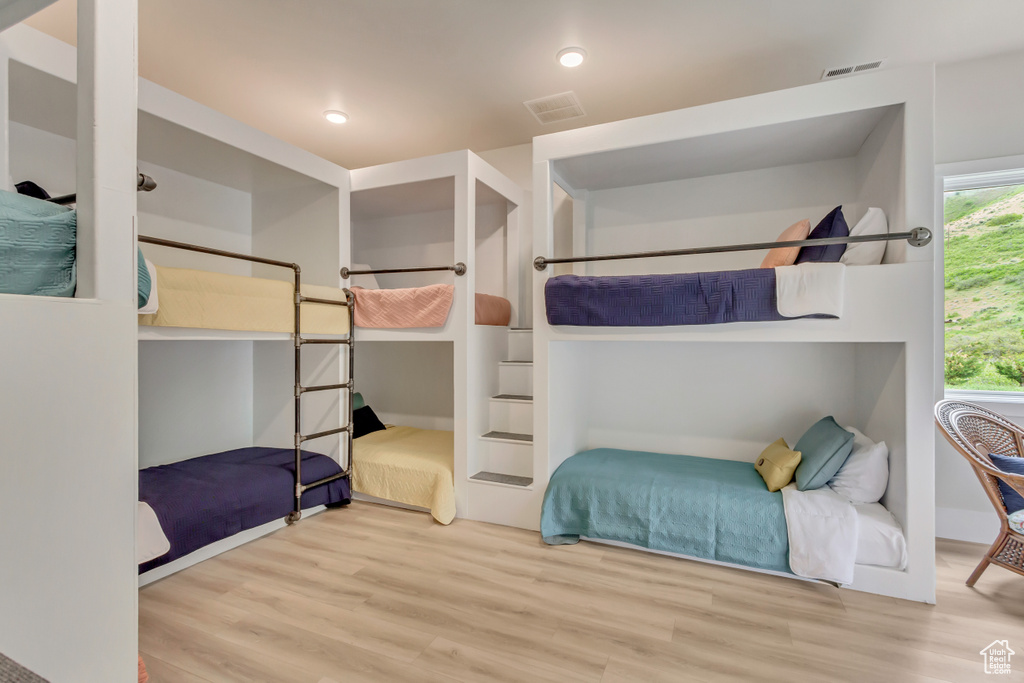 Bedroom with wood finished floors and recessed lighting