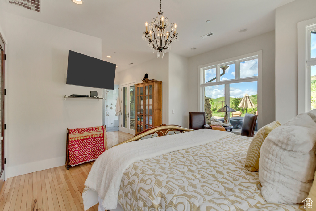 Bedroom featuring light wood finished floors, a chandelier, multiple windows, recessed lighting, and baseboards