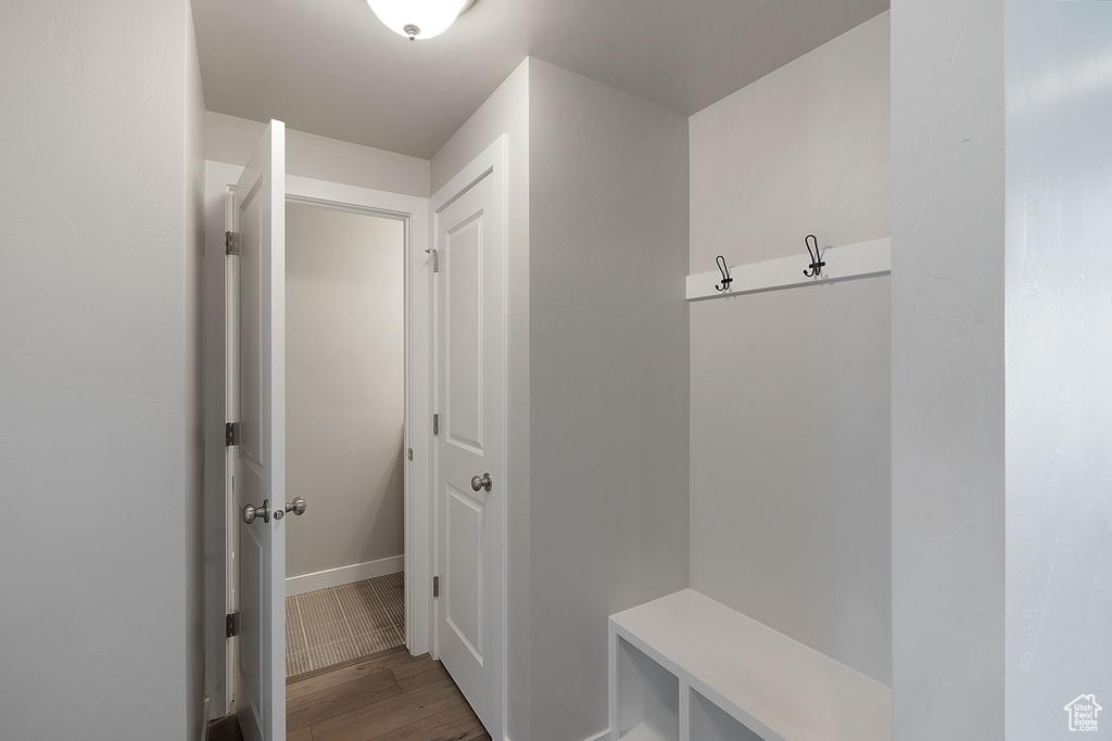 Mudroom featuring wood finished floors and baseboards
