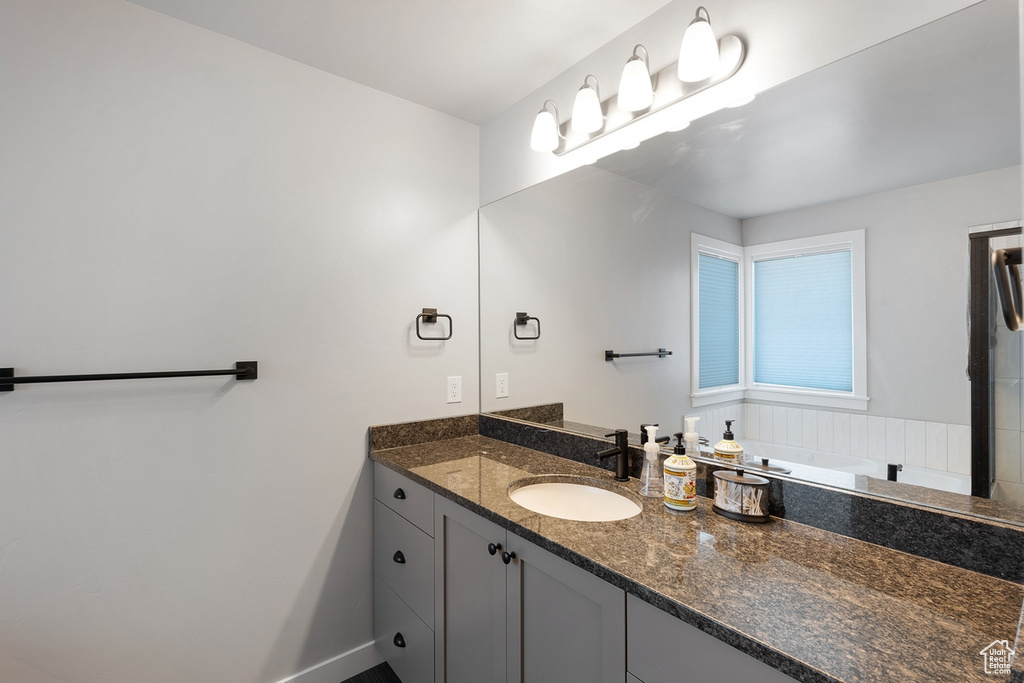 Bathroom with vanity and baseboards