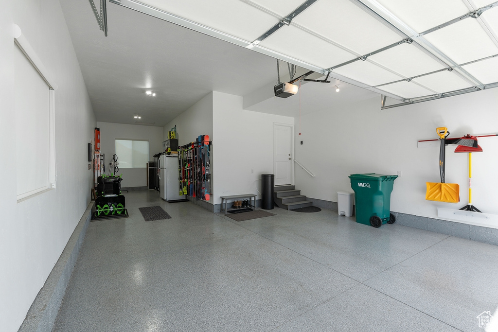 Garage with a garage door opener and baseboards