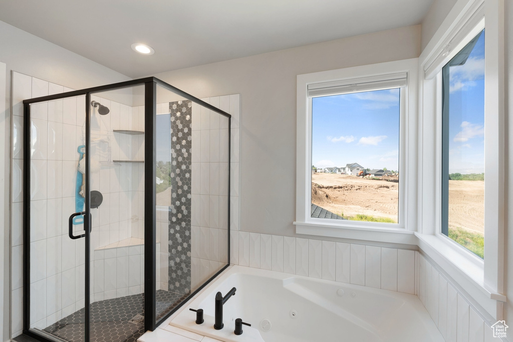 Bathroom with a jetted tub, a shower stall, and recessed lighting
