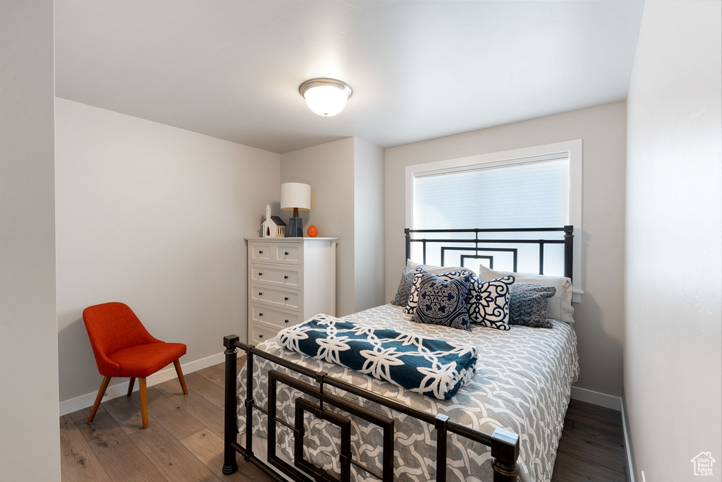 Bedroom with baseboards and wood finished floors