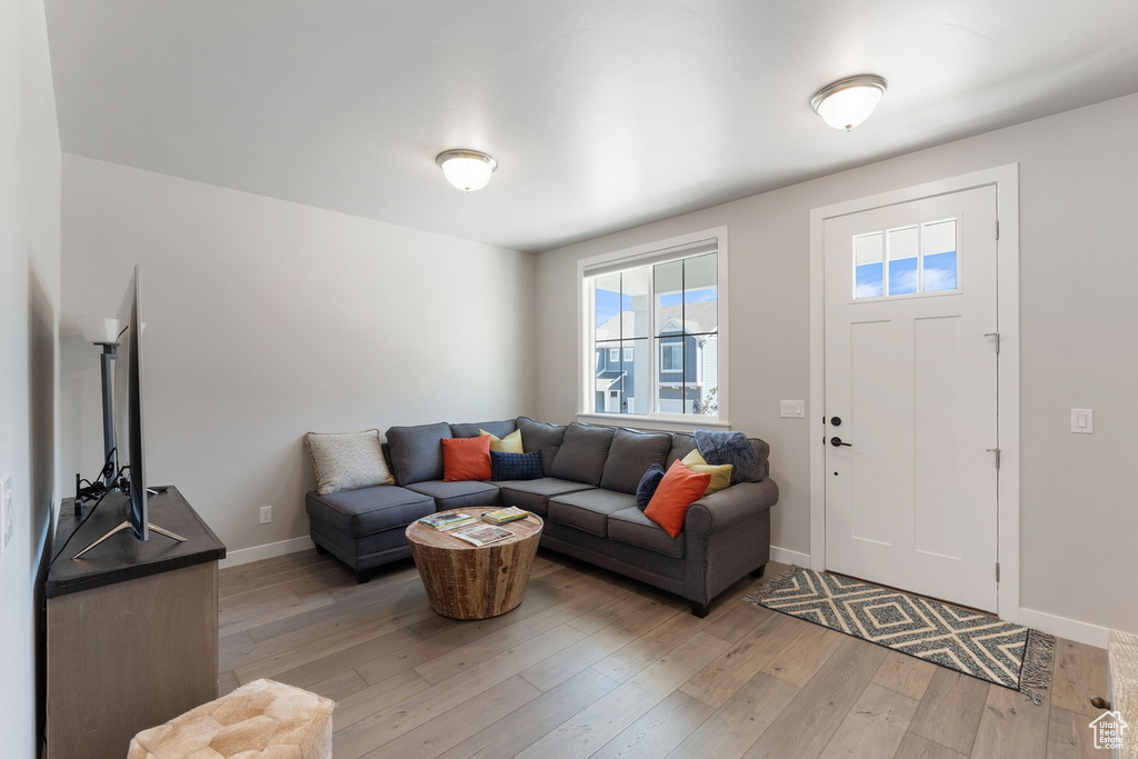 Living room featuring light wood-type flooring and baseboards