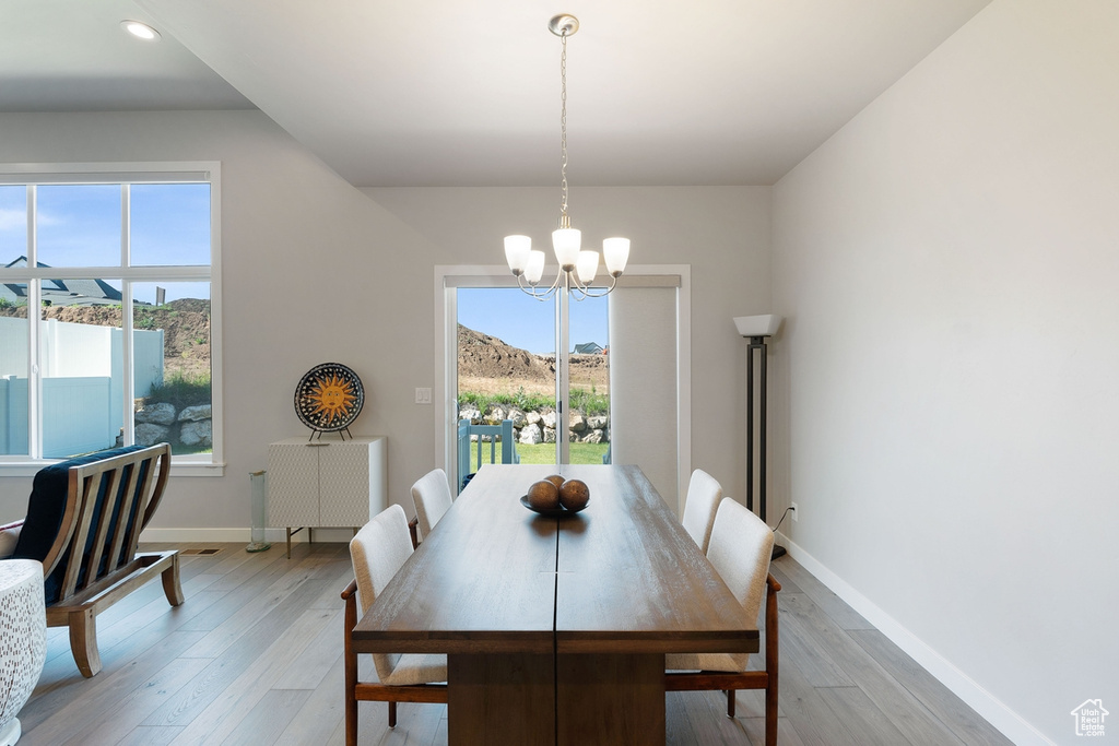 Dining room with a chandelier, light wood-style floors, plenty of natural light, baseboards, and recessed lighting