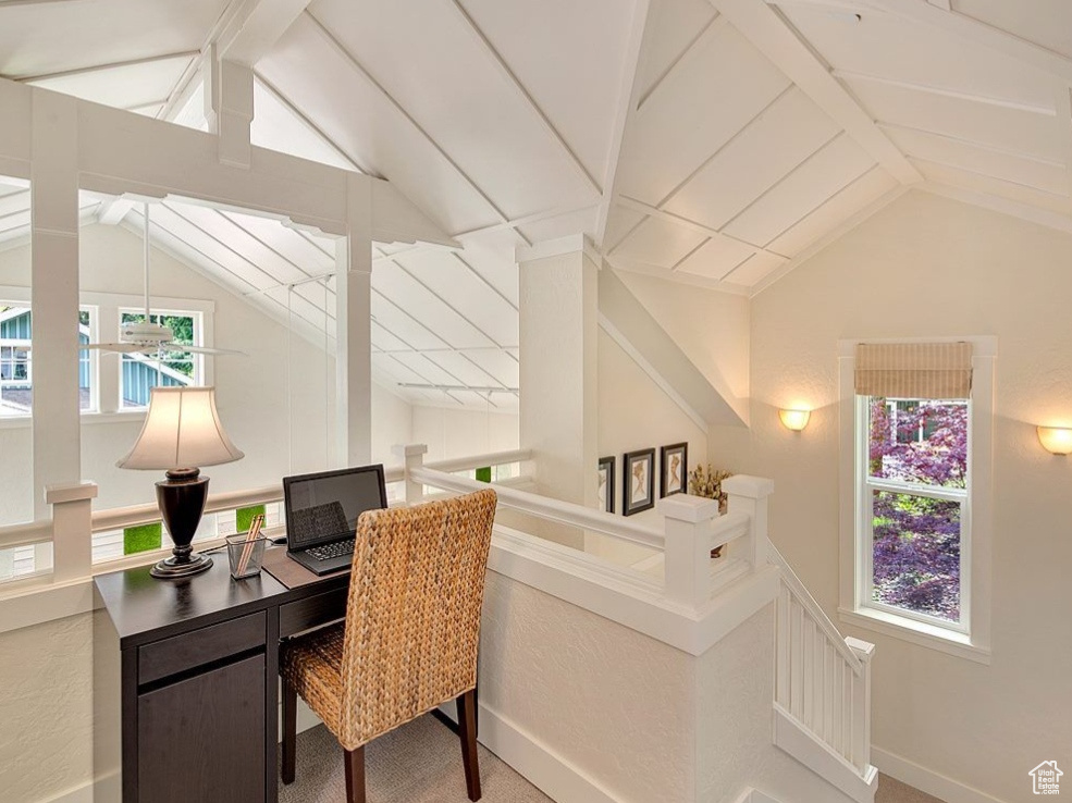 Carpeted home office featuring plenty of natural light