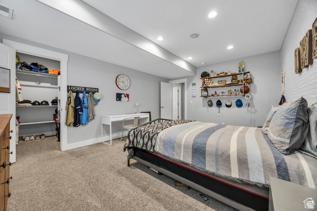 Carpeted bedroom featuring a spacious closet, recessed lighting, and a closet