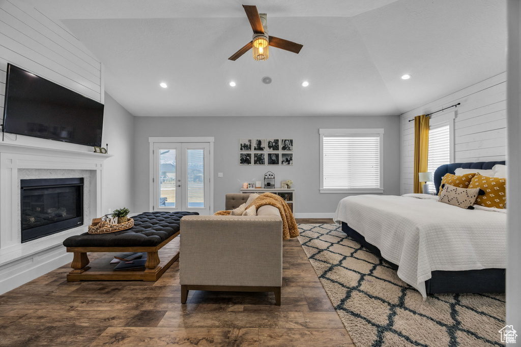 Bedroom featuring vaulted ceiling, access to exterior, dark wood-style flooring, multiple windows, and recessed lighting