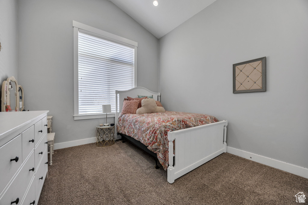 Bedroom with carpet and vaulted ceiling