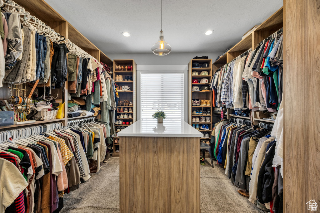 Spacious closet with light colored carpet