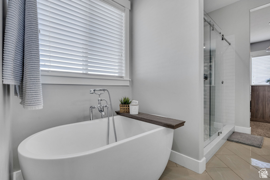 Full bathroom featuring a freestanding bath and a stall shower