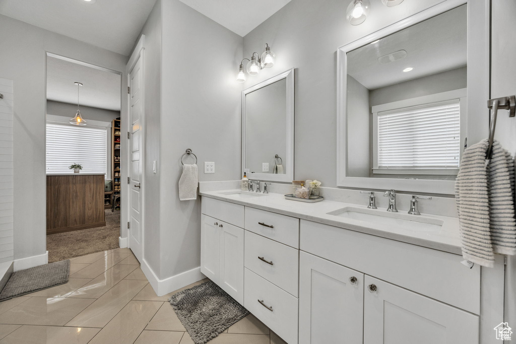 Bathroom featuring double vanity and tile patterned flooring