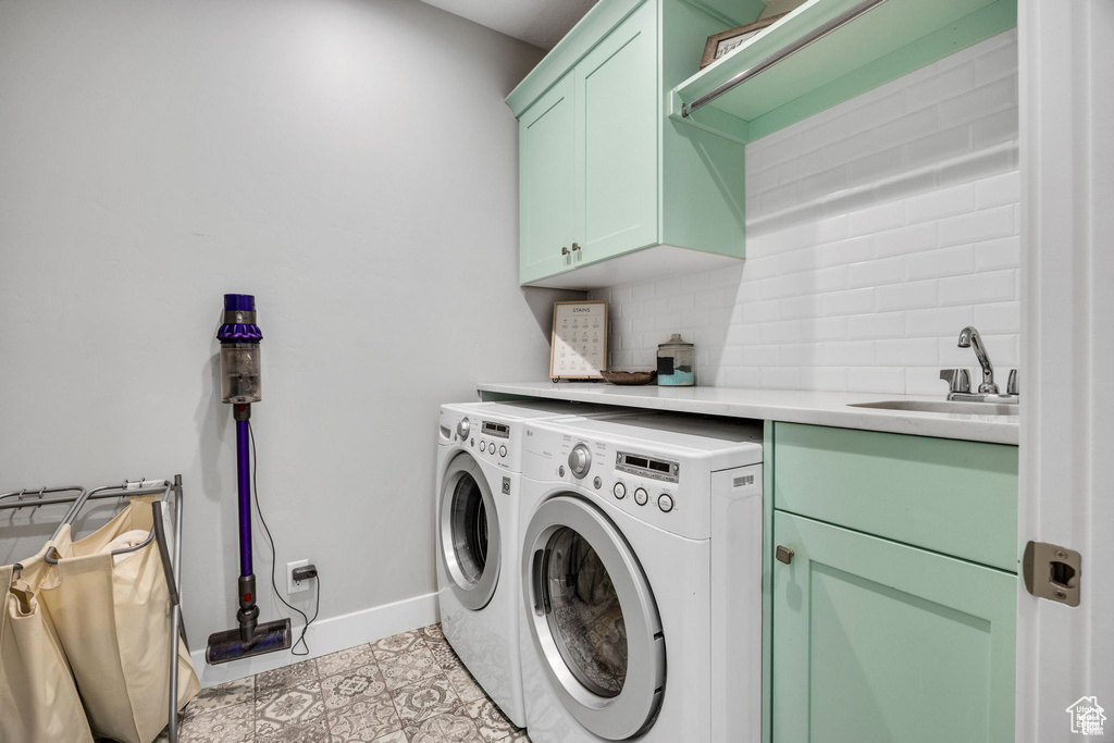 Laundry room with cabinet space and washing machine and clothes dryer