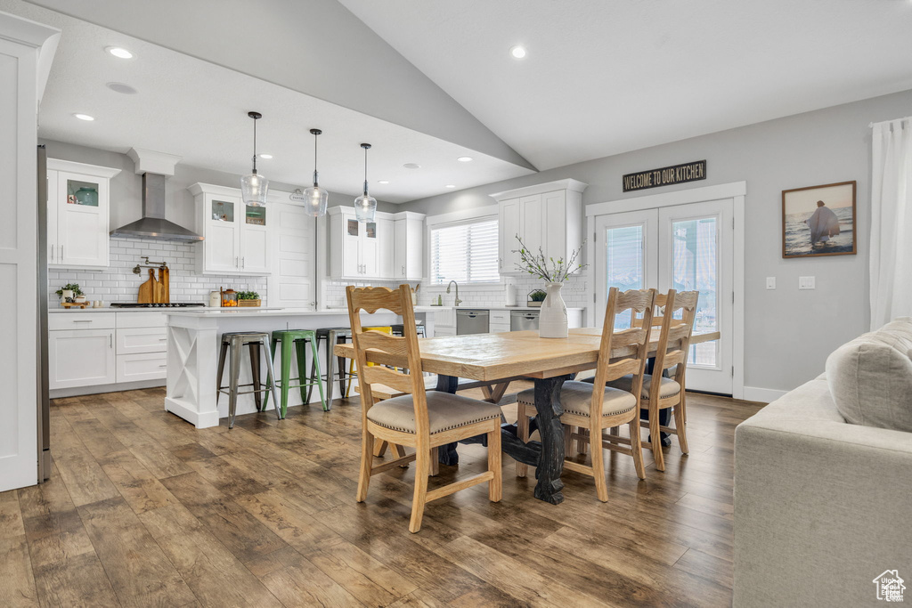 Dining space featuring lofted ceiling, dark wood finished floors, recessed lighting, and french doors