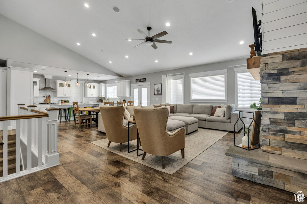 Living room with a ceiling fan, dark wood-style floors, recessed lighting, and high vaulted ceiling