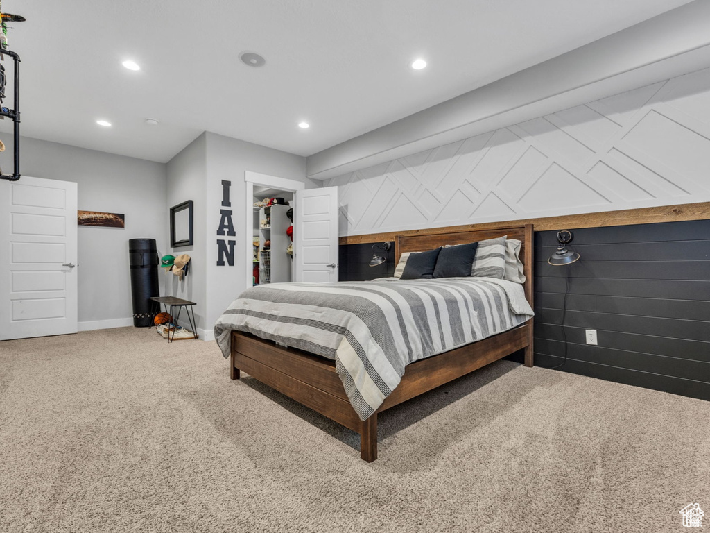 Carpeted bedroom with recessed lighting and a spacious closet