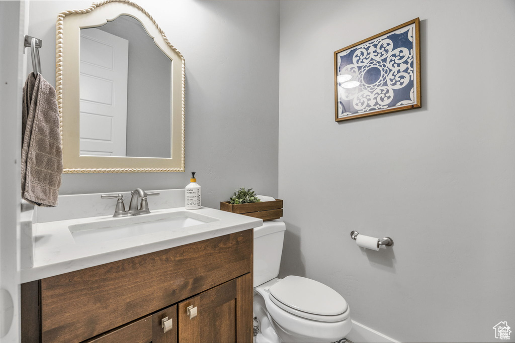 Half bath featuring toilet and vanity