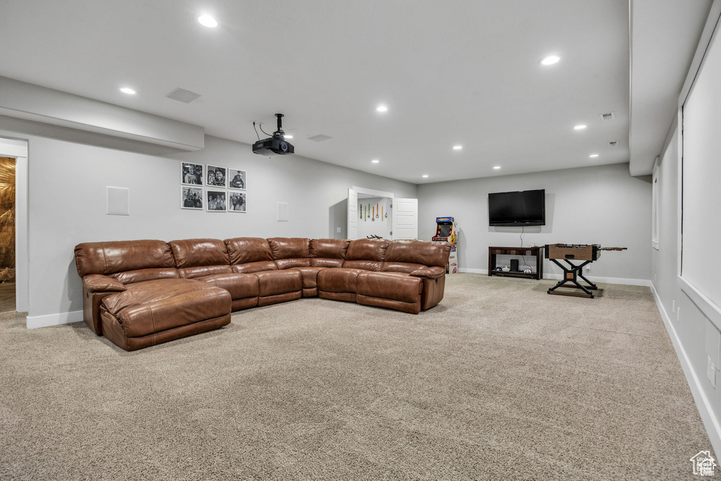Living area with carpet floors and recessed lighting