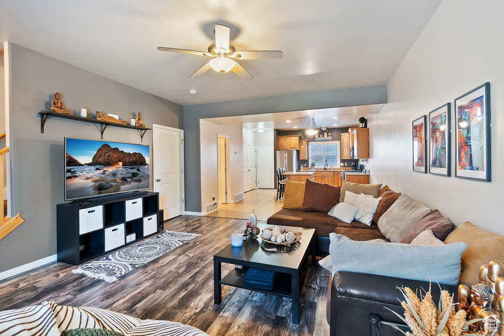 Living room with ceiling fan and wood finished floors