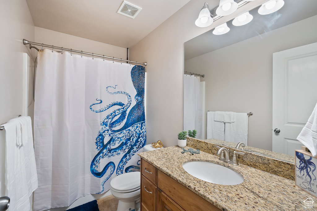 Full bathroom with vanity, radiator, and curtained shower