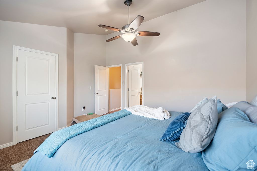 Bedroom featuring carpet flooring, high vaulted ceiling, and a ceiling fan