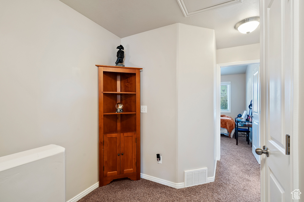 Corridor with carpet and baseboards