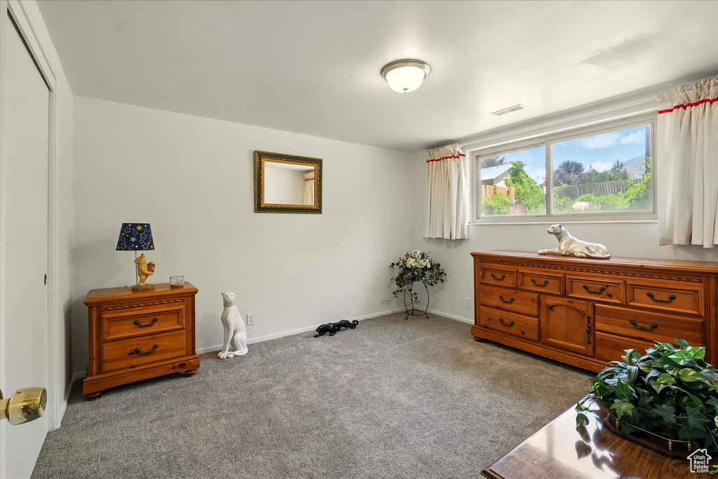 Sitting room featuring carpet and baseboards