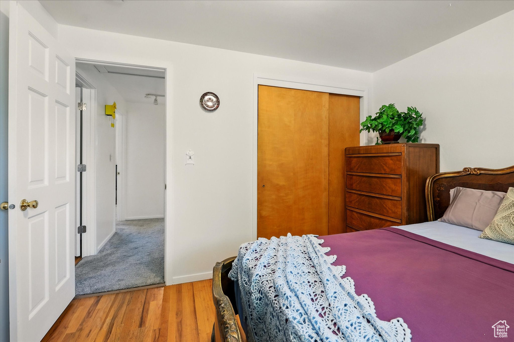 Bedroom featuring wood finished floors and a closet