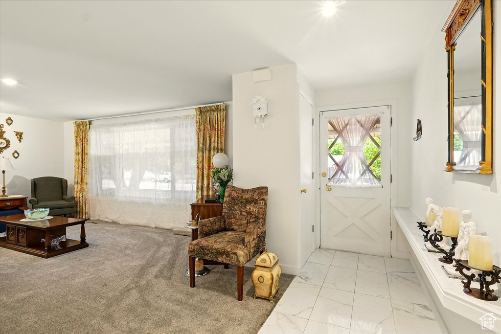 Living room with plenty of natural light and light marble finish flooring