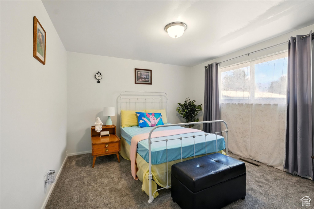 Bedroom featuring carpet flooring and baseboards