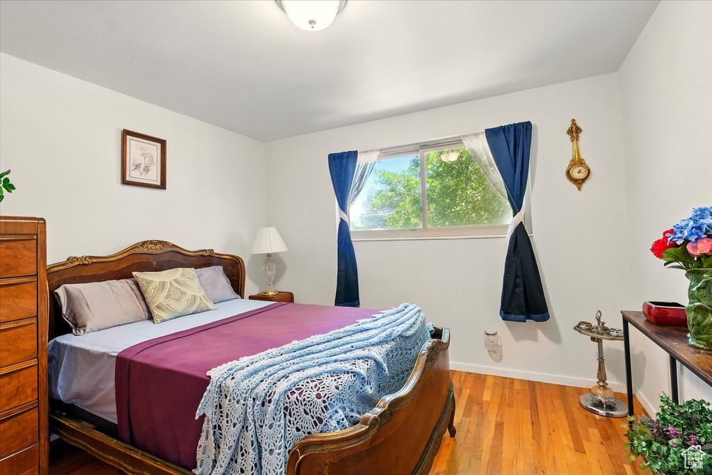 Bedroom featuring wood finished floors and baseboards