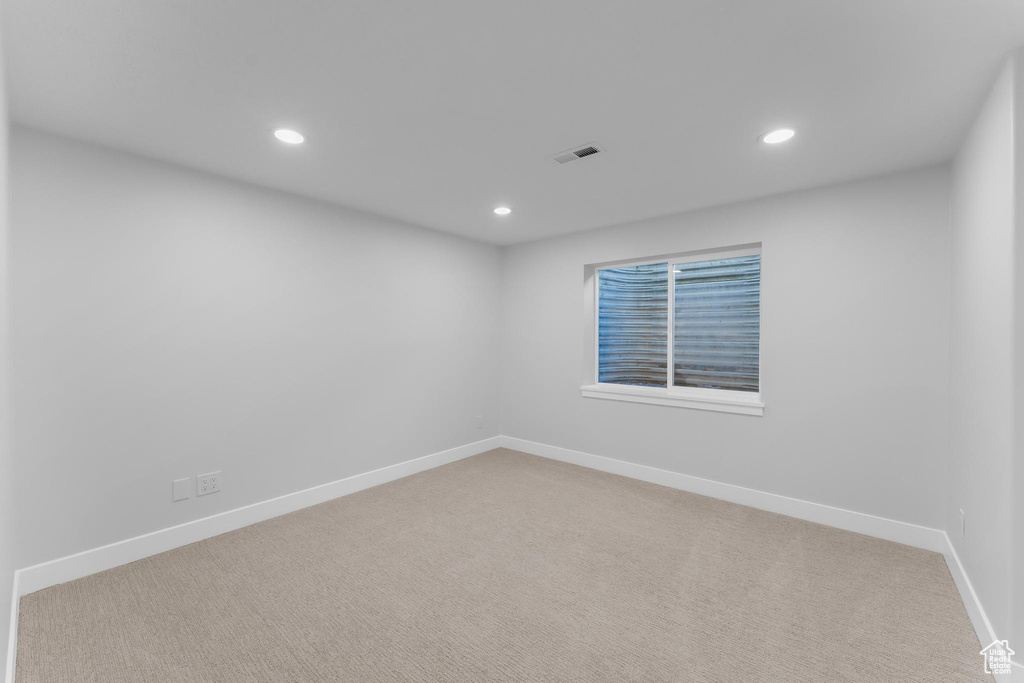 Spare room with recessed lighting, carpet flooring, and baseboards