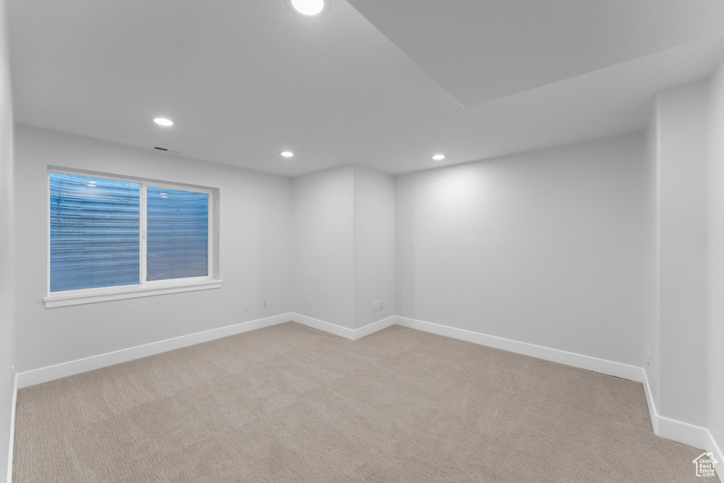 Carpeted spare room featuring recessed lighting and baseboards