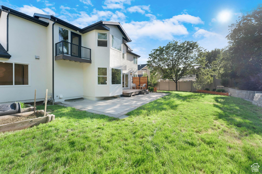 View of yard featuring a balcony and a patio area