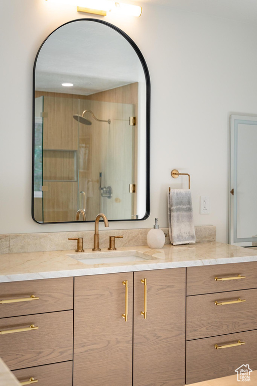 Bathroom with vanity and a walk in shower