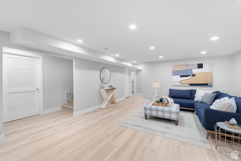 Living room with stairway, recessed lighting, wood finished floors, and baseboards