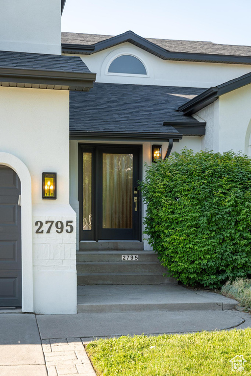 Property entrance featuring stucco siding