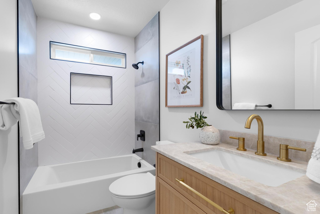 Full bathroom featuring vanity, toilet, and bathtub / shower combination