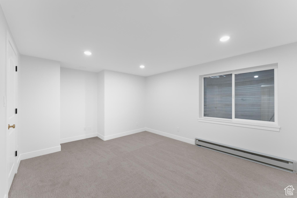 Unfurnished room with a baseboard radiator, recessed lighting, carpet floors, and baseboards